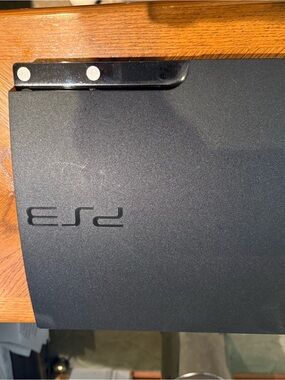 Sony PS3 Slim Matte Black Gaming Console Top View with games